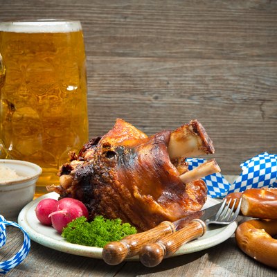 Roasted pork knuckle with pretzels and beer.