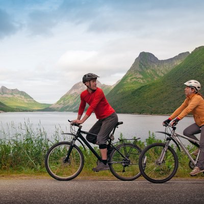 two cyclists relax biking