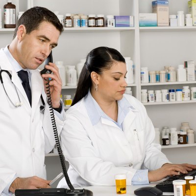 Pharmacist on computer and doctor using phone