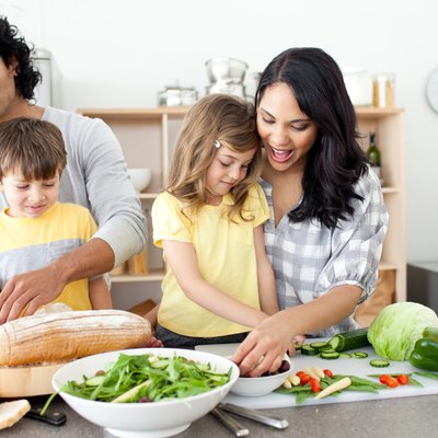 Positive family preparing lunch together