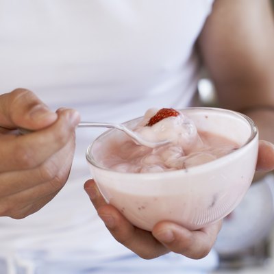 Hands holding yogurt