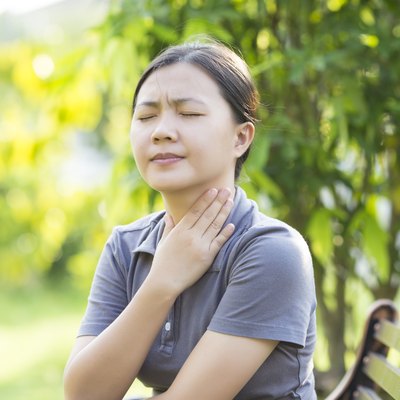 Woman has Sore Throat at Park
