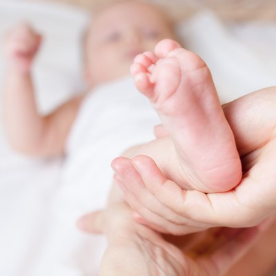 Mother makes healthy massage for baby