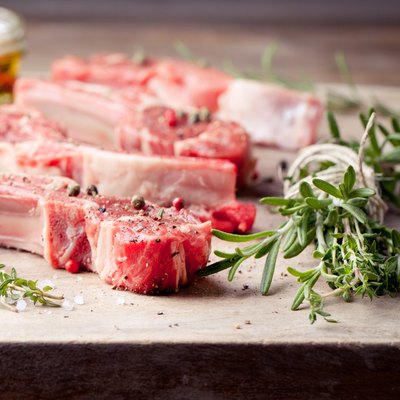 Raw meat, mutton, lamb rack on a wooden background