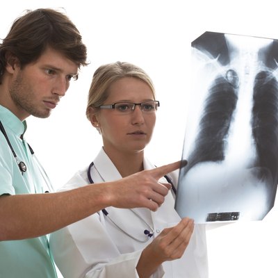 Pulmonologist and surgeon watching x-ray