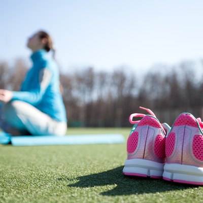 woman practicing yoga in a park