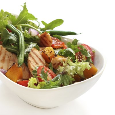 A grilled chicken salad in a bowl