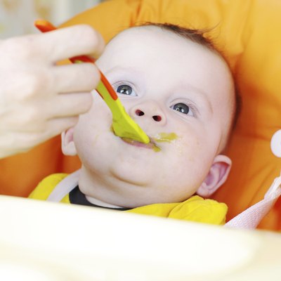baby is fed by puree
