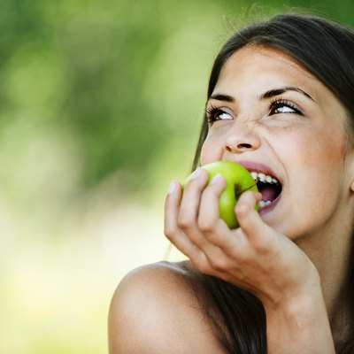 portrait young charming woman biting apple
