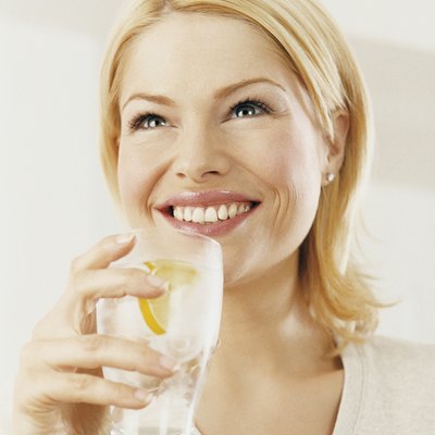 Portrait of a Woman Enjoying a Drink of Water With a Slice of Lemon