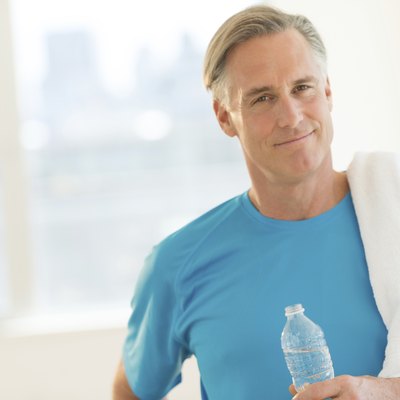 Confident Man With Towel And Water Bottle At Club
