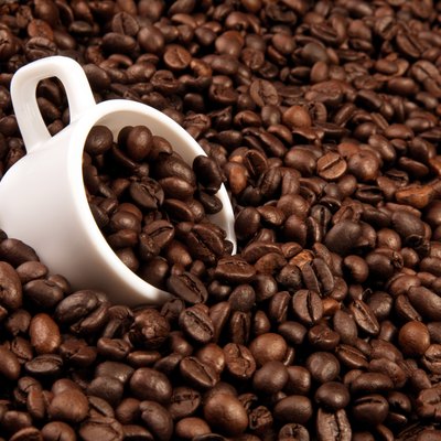 white cup with coffee beans