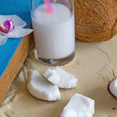 Relaxation at the beach with coconuts, coconut milk and orchid