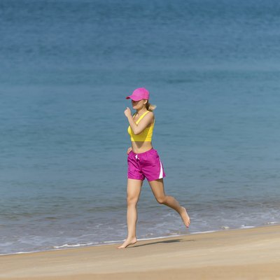 Healthy Woman running on beach