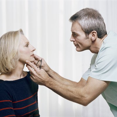 Cosmetic Surgeon Examining a Patients Face