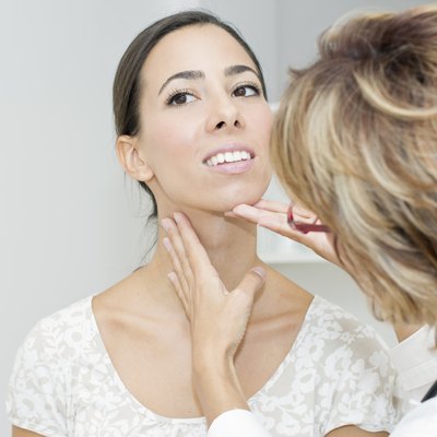 Mature female doctor examining her patient