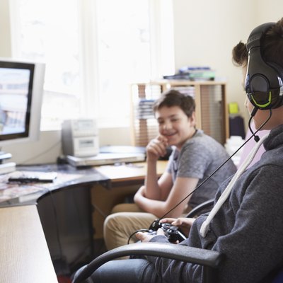 Two boys playing on computer game