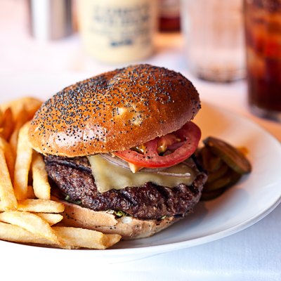 Cheese burger and french fries on restaurant table