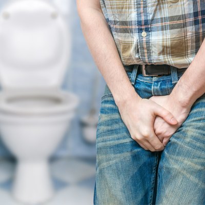 Incontinence concept. Man wants pee and is holding his bladder