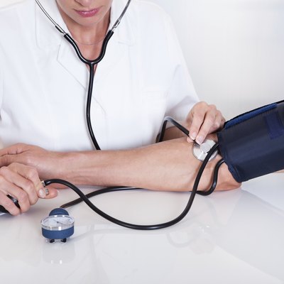 Doctor taking a patients blood pressure