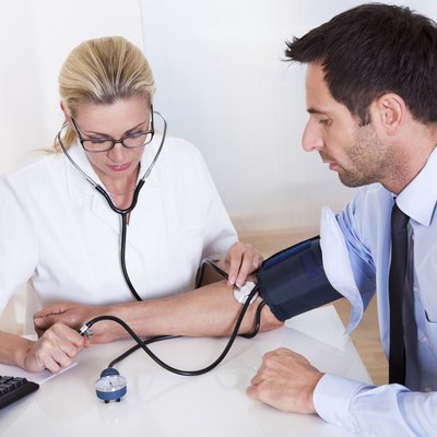Doctor taking a patients blood pressure
