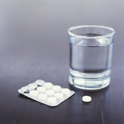 Glass of water and pills, close up