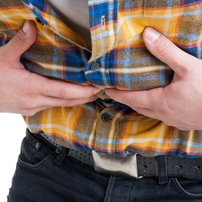 Close up of male with discomfort and stomach cramps