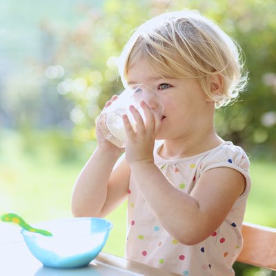 Little girl having breakfast indoors