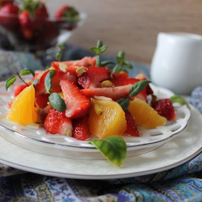 fruit salad with strawberries, oranges, pistachios