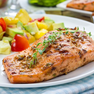 Spice grilled salmon with mango-avocado salsa on a white plate