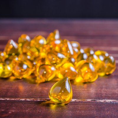 Fish oil on wooden texture background