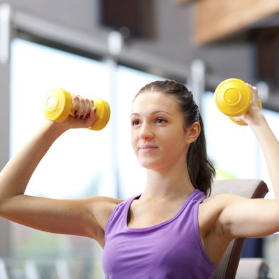 Young woman lifting weights