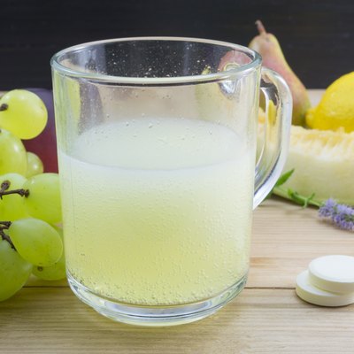 Effervescent tablets and dissolved tablet in a glass with bunch