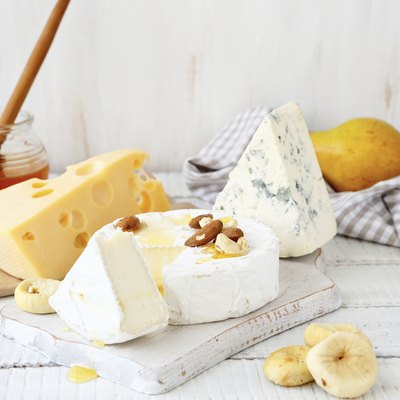 Different cheeses on a cutting board