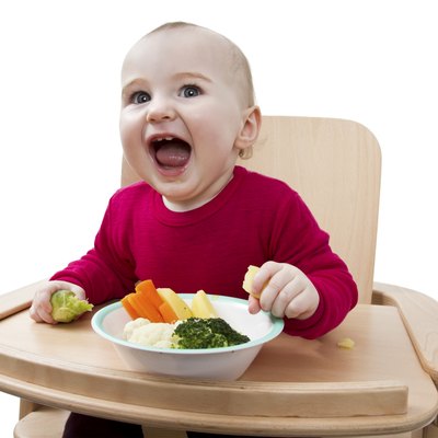 young child eating in high chair
