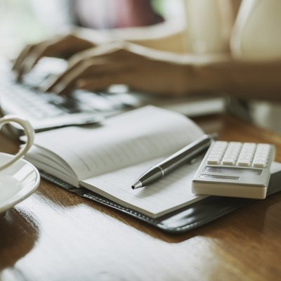 writer typing in a laptop