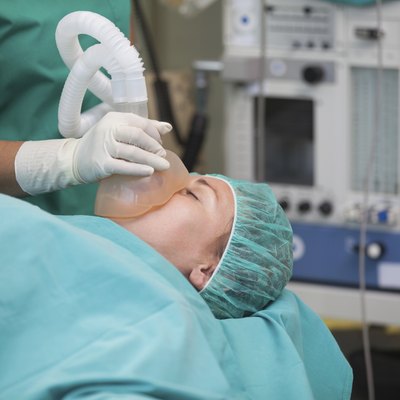 Nurse putting an oxygen mask