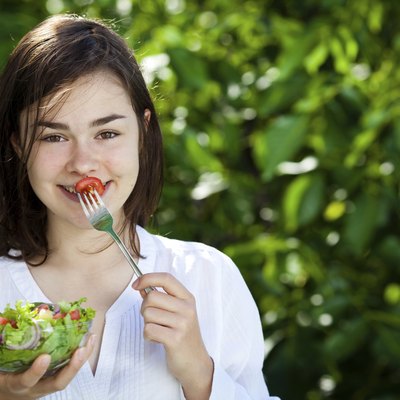 Girl eating vegetable salad