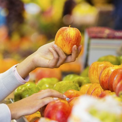 Woman buys fruits and vegetables at a market
