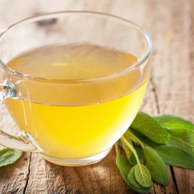 herbal sage tea with green leaf in glass cup