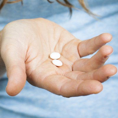 Close-up of hand holding pills