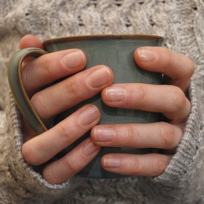 Two hands holding a mug of drink