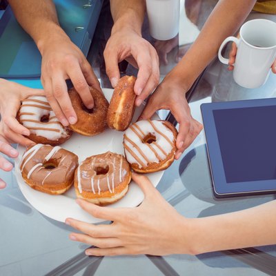 Fashion students eating doughnuts