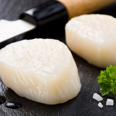 Scallops on black stone plate