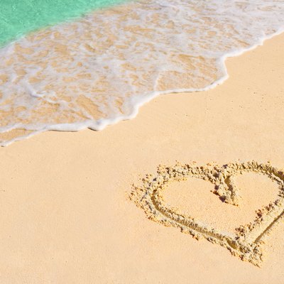 Drawing heart on beach