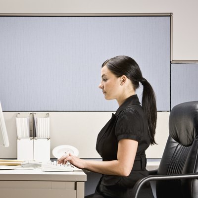Businesswoman Typing on Computer at Desk