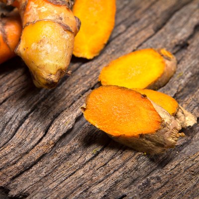 turmeric root on wooden plate