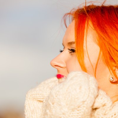 Beauty face redhaired woman in warm clothing outdoor