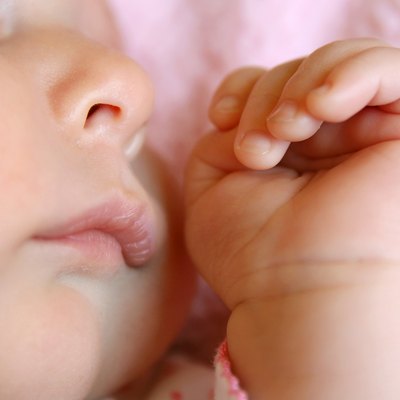 Close up on Hands and Face of Sleeping Baby