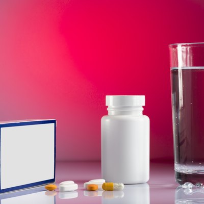 Various pills and glass of water